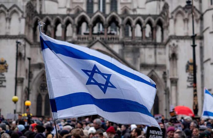 Israeli flag at a crowded outdoor event.