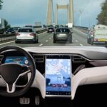 Car interior with self-driving mode on highway.