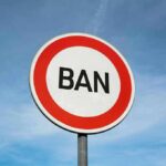 a circular sign with rings of white and red that reads BAN