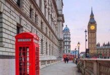 Red telephone booth near Big Ben in London.