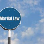 Rising Unrest Leads To Drastic Measures In South Korea Martial Law sign against blue sky background