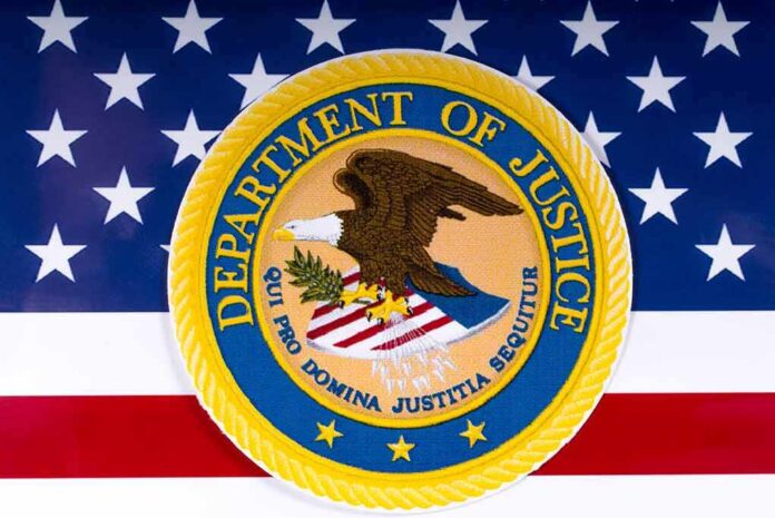 1054857686 featured image Department of Justice seal on American flag background.