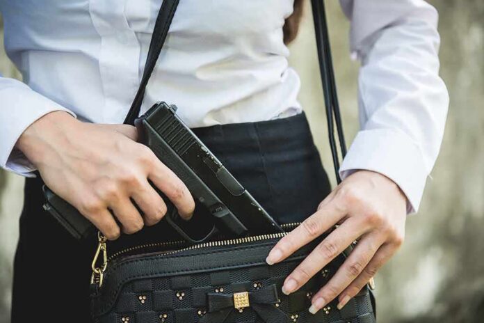 1833767482 featured image Person placing gun into a handbag.