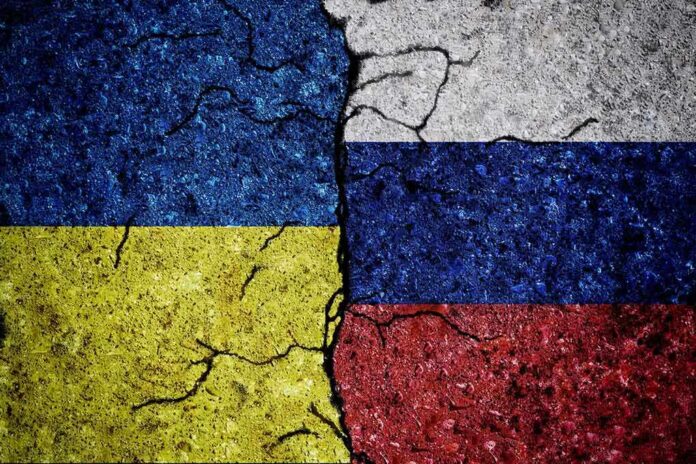 2030856296 featured image Cracked Ukrainian and Russian flags painted on concrete.