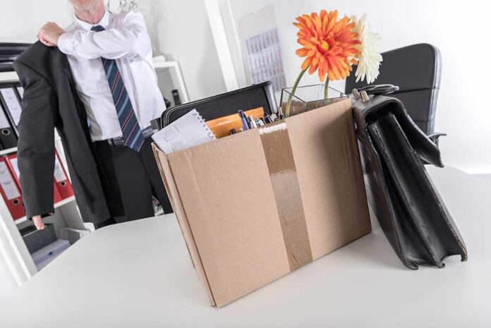 325505735 featured image Cardboard box with office items and flowers