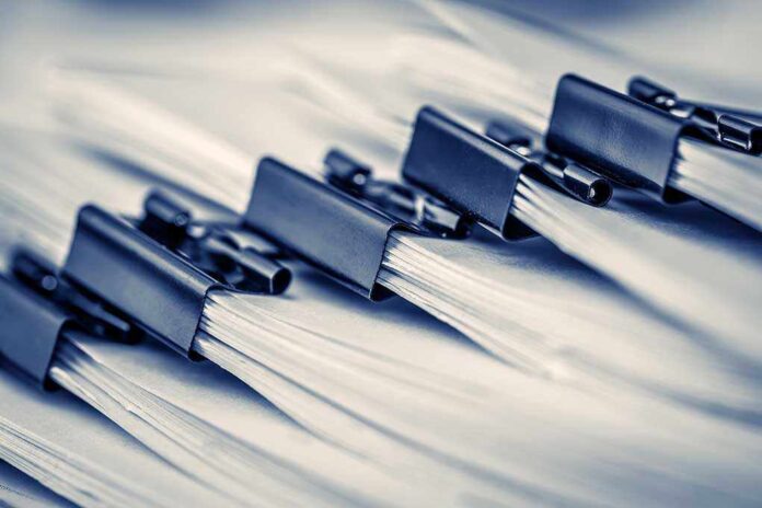 709205902 featured image Close-up of clipped stacks of paper documents.