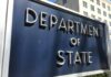 Department of State sign in front of building.