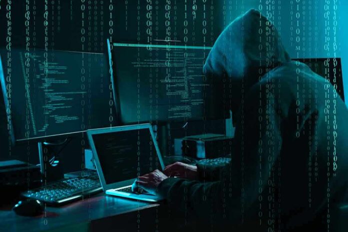 1703023243 featured image Hacker at computer with digital code overlay.