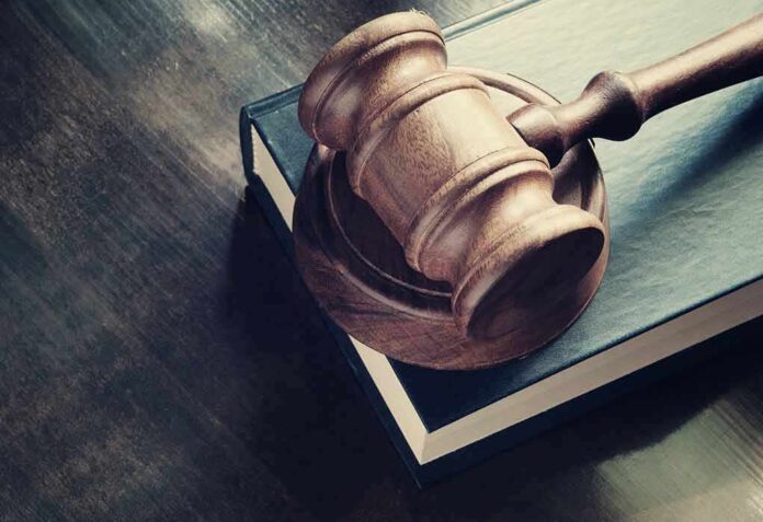 299616500 featured image Wooden gavel resting on thick book