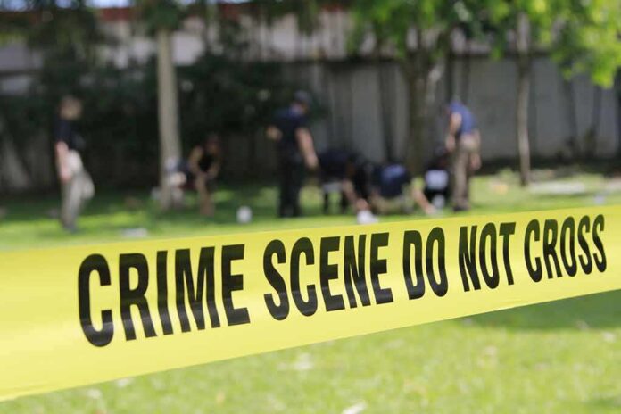 308657879 featured image Yellow crime scene tape blocking grassy area.