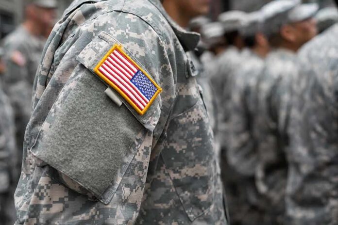370106177 featured image People in camouflage uniforms with US flag patch