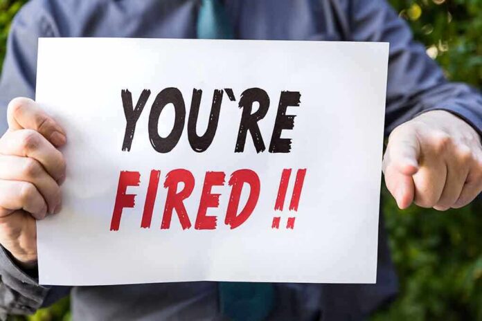 388134190 featured image Person holding YOU'RE FIRED!! sign.