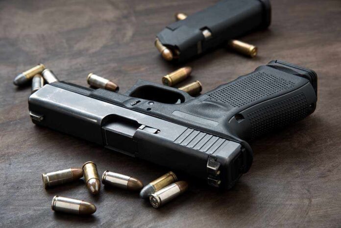 690995188 featured image Handgun with bullets on a wooden surface.