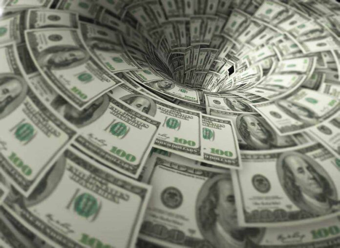760572118 featured image Hundred-dollar bills swirling into a financial vortex.