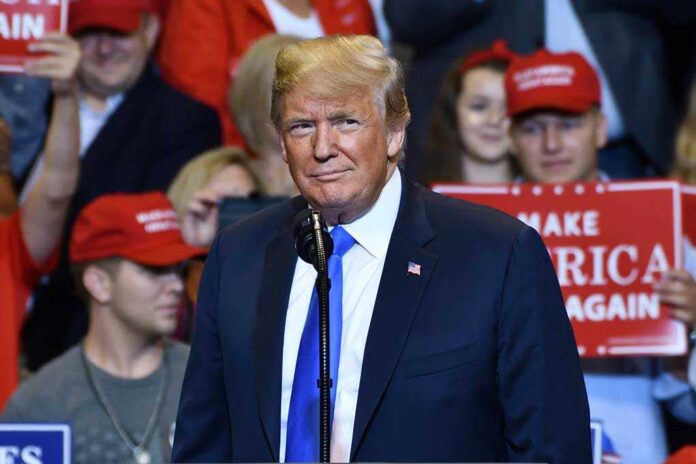 1149680009 featured image Person speaking at a rally with supporters behind.