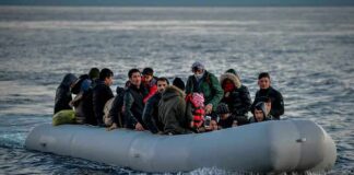 People on a packed raft in open water