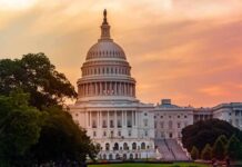 United States Capitol building at sunset with trees