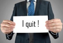 Person holding a sign saying I quit!