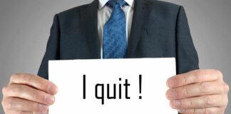 Person holding a sign saying I quit!