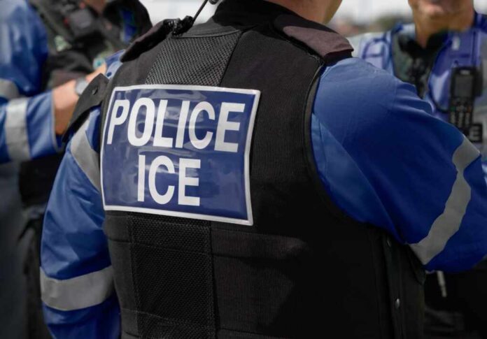 2615419741 featured image Police officer wearing vest with ICE label