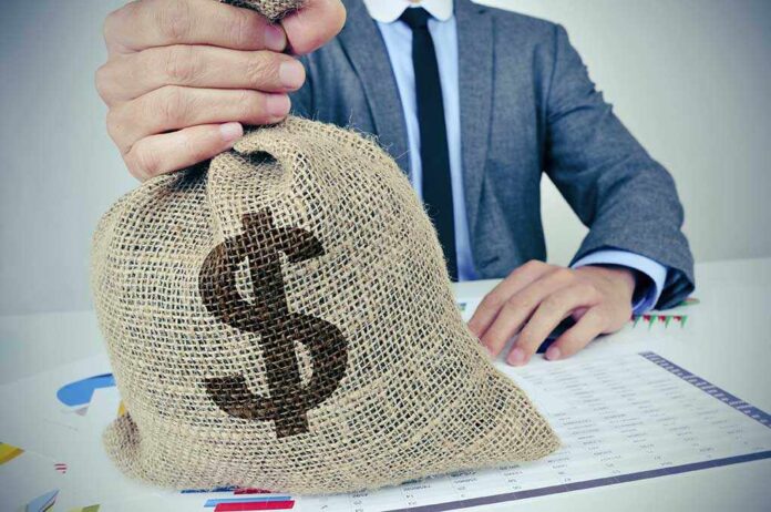 324821675 featured image Person holding burlap sack with dollar sign.
