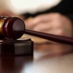 Gavel resting on a wooden sound block