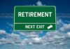 Green road sign reading retirement next exit sky background