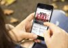 Person holding smartphone displaying fake news notification