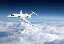 Private jet flying above the clouds