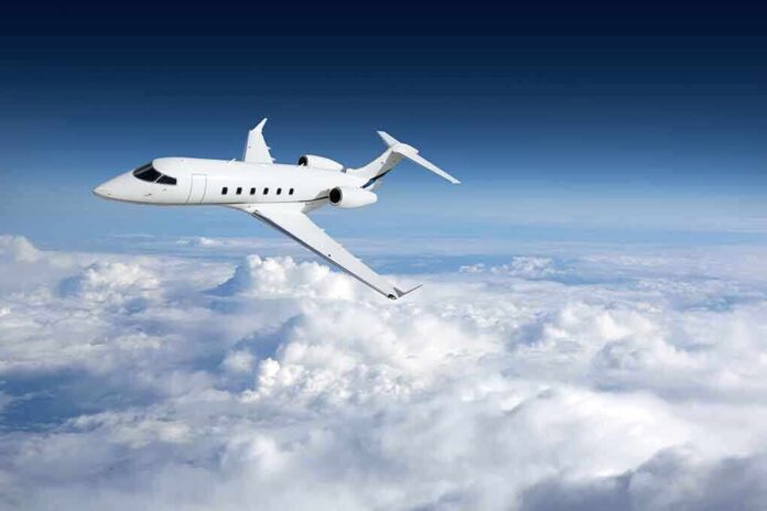 758054764 featured image Private jet flying above the clouds