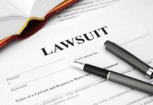 Legal document titled lawsuit with pen and book.