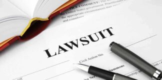 Legal document titled lawsuit with pen and book.