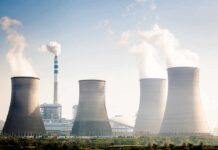 Four cooling towers of a power plant emitting steam
