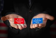 Hands holding Republican and Democratic Party cards