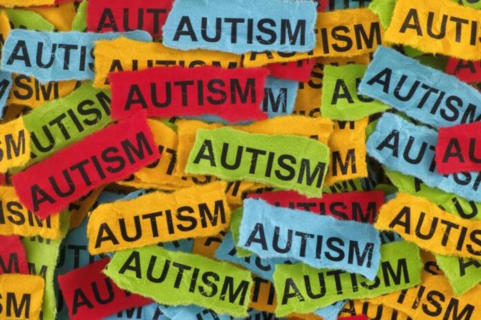 Colorful torn papers with the word autism repeated