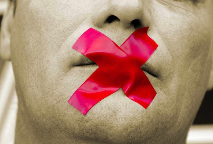 2800240 featured image Man with red tape over mouth for hate speech