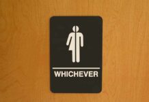 Bathroom sign reading whichever on door