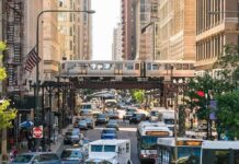 Busy street with elevated train and cars below