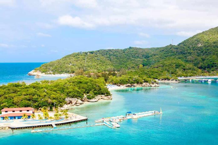 Tropical beach with docks and lush green hills