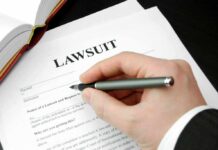 Filling out lawsuit form with pen