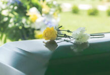 Flowers on a closed casket at a funeral