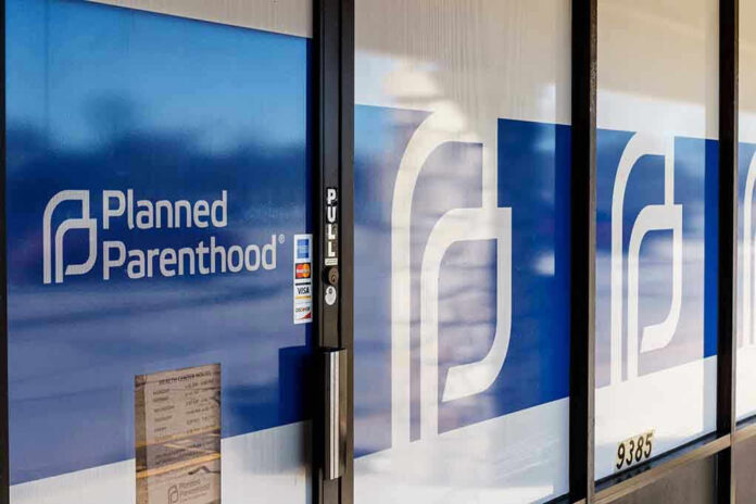 1348319024 Planned Parenthood office entrance with logo and signs