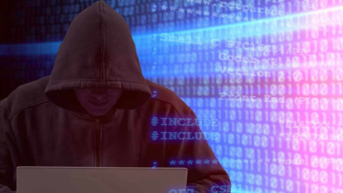 Person in hoodie using laptop, surrounded by digital code