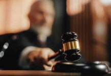 Judge using gavel in a courtroom setting.