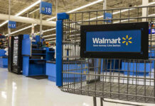 Walmart shopping cart inside store near checkout aisle