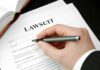 Filling out lawsuit form with pen