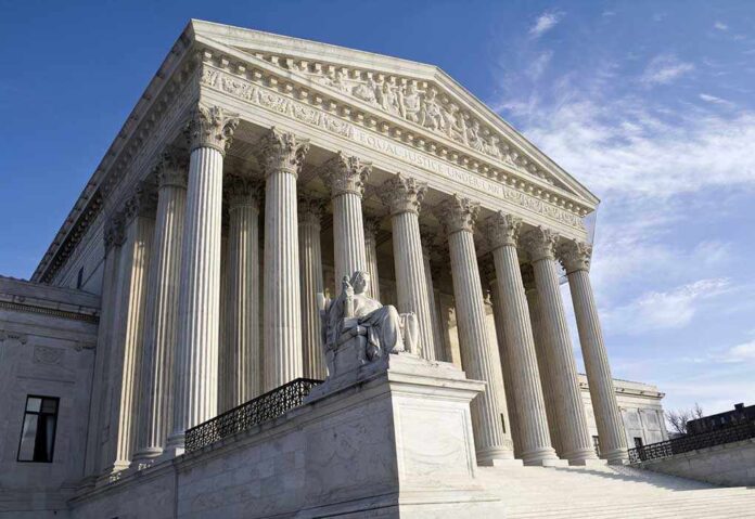 shutterstock_104498510.jpg Exterior view of the Supreme Court building with columns and a statue of justice