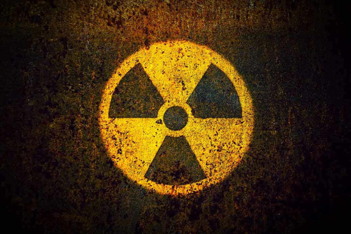Yellow radiation warning symbol on rusty metal surface