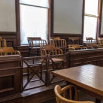Empty jury box and table in courtroom.