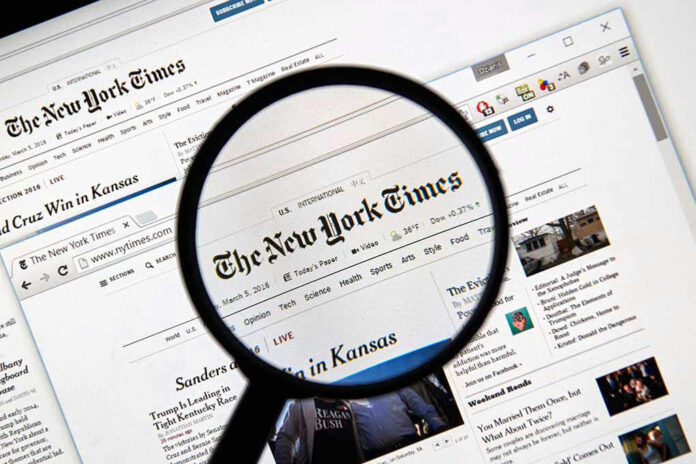 Magnifying glass over The New York Times website.